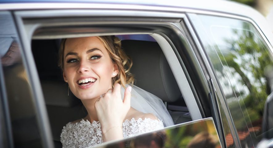 bride smiling on a limo