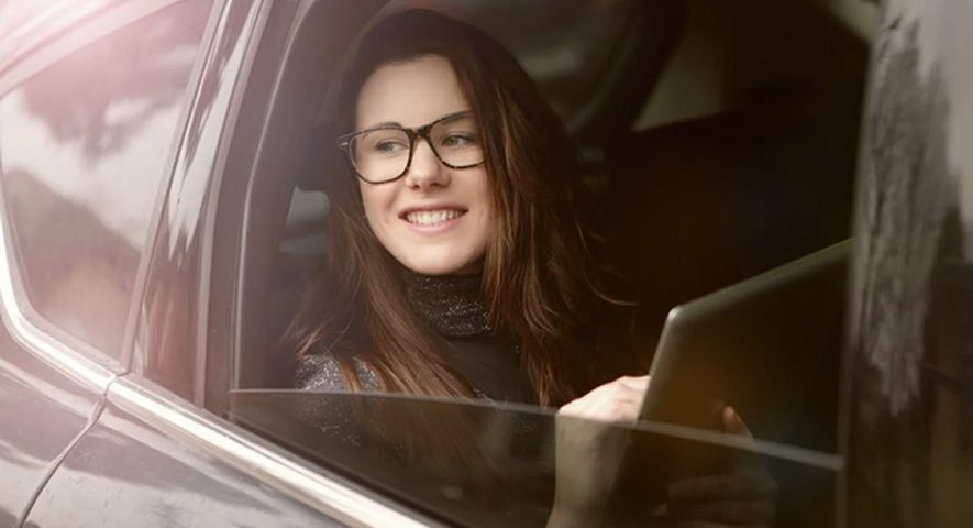 girl smiling on car's window